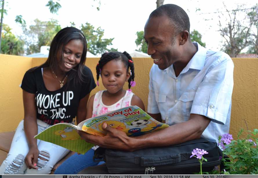 Henri Francois reads to his daughters